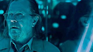 Gary Oldman in Slow Horses Season 5, in blue light with an odd expression that may be disdain or disgust