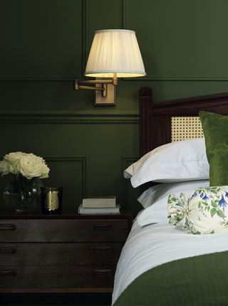 A bedroom with dark green paint
