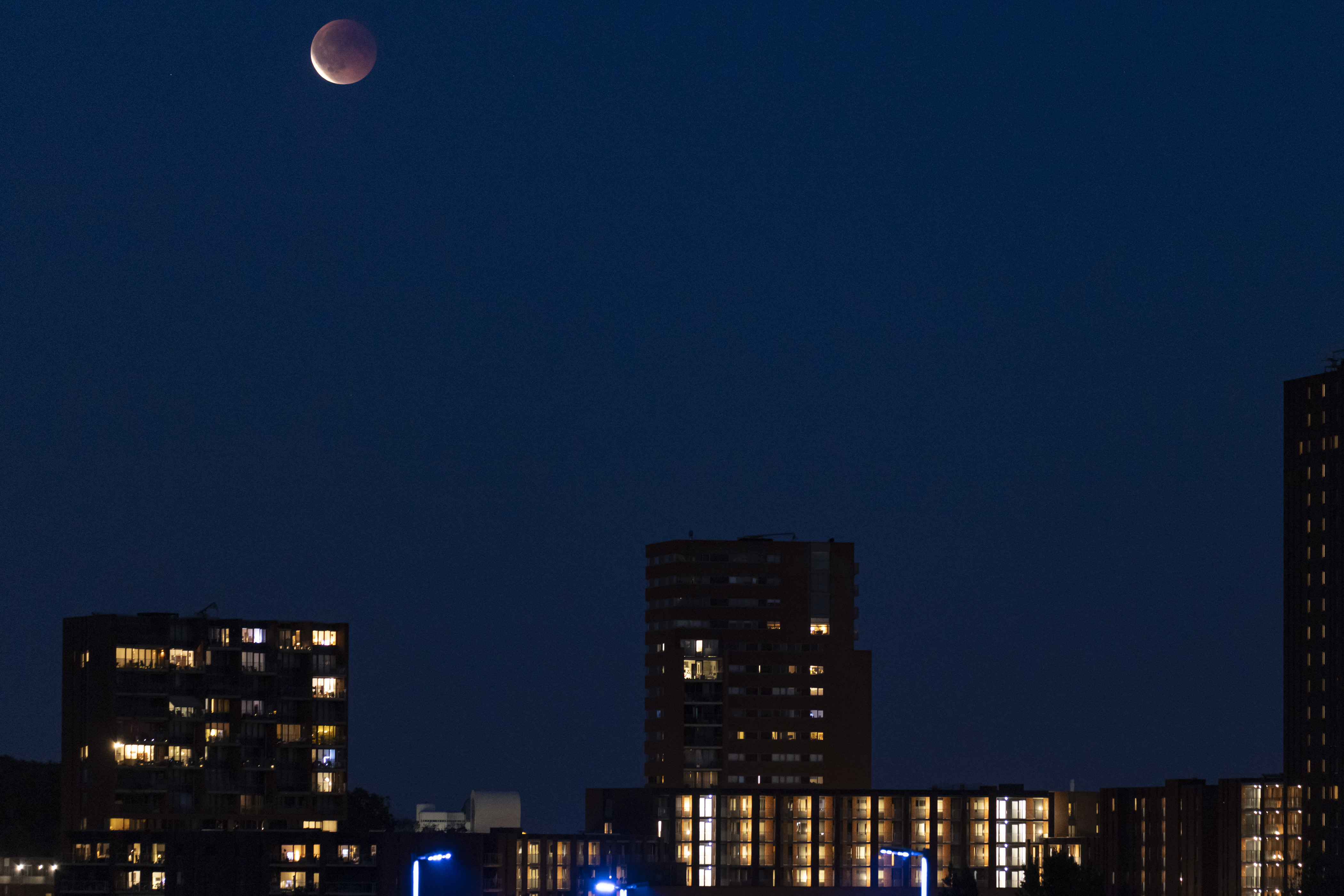 A photograph of the &quot;blood moon&quot; above residential buildings in Eindhoven, the Netherlands