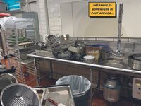 Realistic digital artwork of a cluttered washing up area in a canteen kitchen