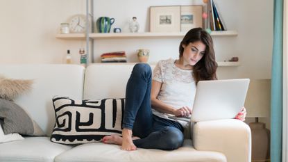 Woman play online bike game in the living room of her home