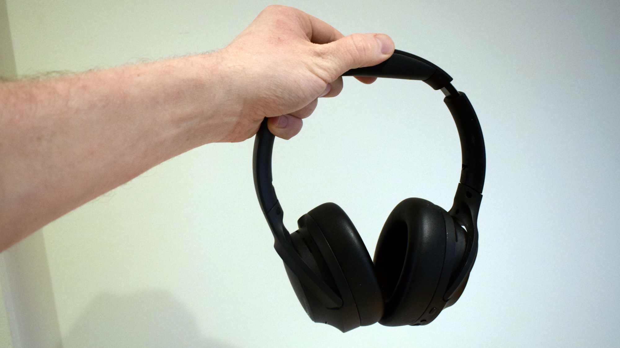 The Soundpeats Cove Pro in a man's hand.