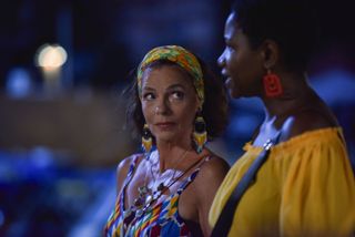 Catherine Bordey (Élizabeth Bourgine) and Darlene Curtis (Ginny Holder) go for a walk together in the evening. Catherine is looking towards Darlene in a supportive manner. The background is out of focus.