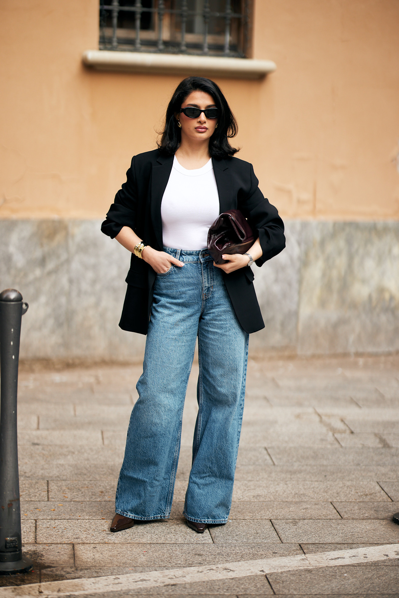 woman wearing a blazer, a tee, and wide-leg jeans