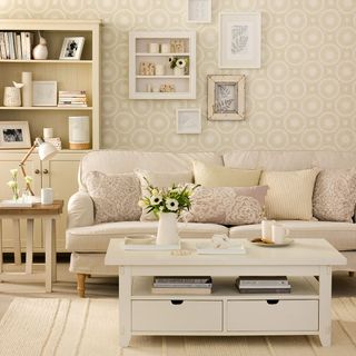 Living room with cream sofa and cream wallpaper