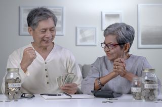 Asian senior couple plans to save money to spend after retirement.