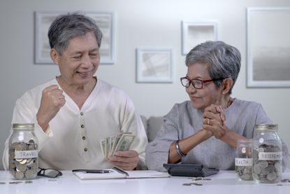 Asian senior couple plans to save money to spend after retirement.