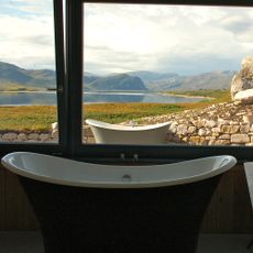 indoor black bathtub with mountain lake side view