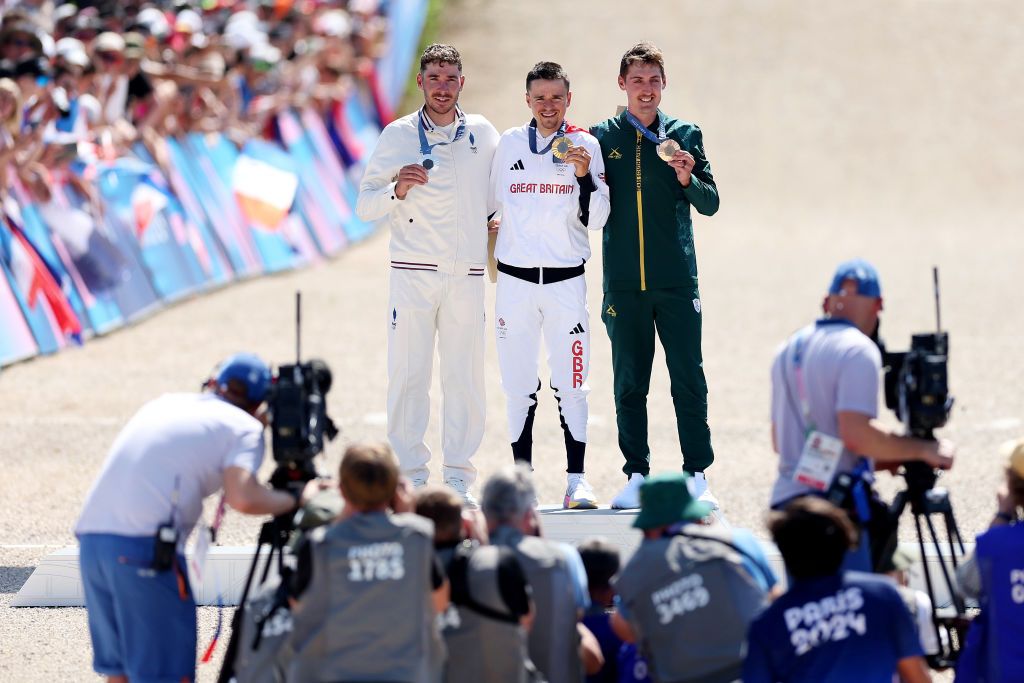 ELANCOURT FRANCE JULY 29 Gold medalist Thomas Pidcock of Team Great Britain C Silver medalist Victor Koretzky of Team France L and Bronze medalist Alan Hatherly of Team South Africa R pose on the podium during the Mens CrossCountry on day three of the Olympic Games Paris 2024 at Elancourt Hill on July 29 2024 in Elancourt France Photo by Tim de WaeleGetty Images
