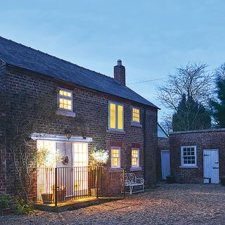 exterior with cottage and brick wall