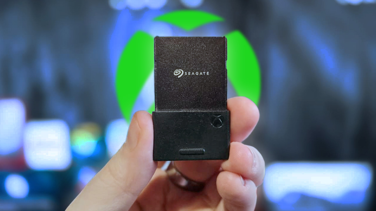 Seagate Expansion Card for Xbox held in hand, in front of Xbox logo