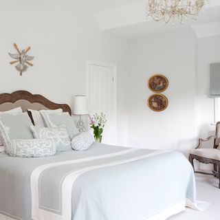 bedroom with white wall and chandelier