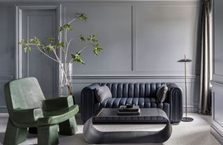 contemporary living room with purple sofa, green chair and silver coffee table