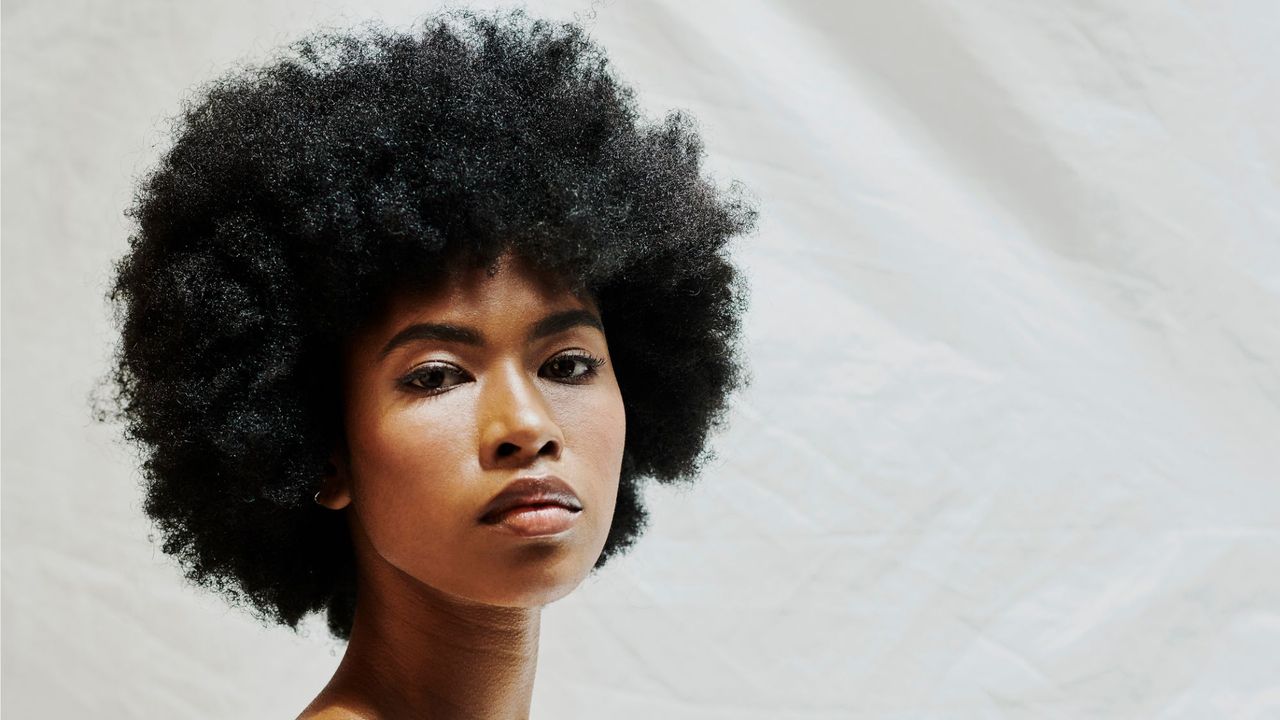 a picture of a woman looking at the camera - how to properly wash your hair