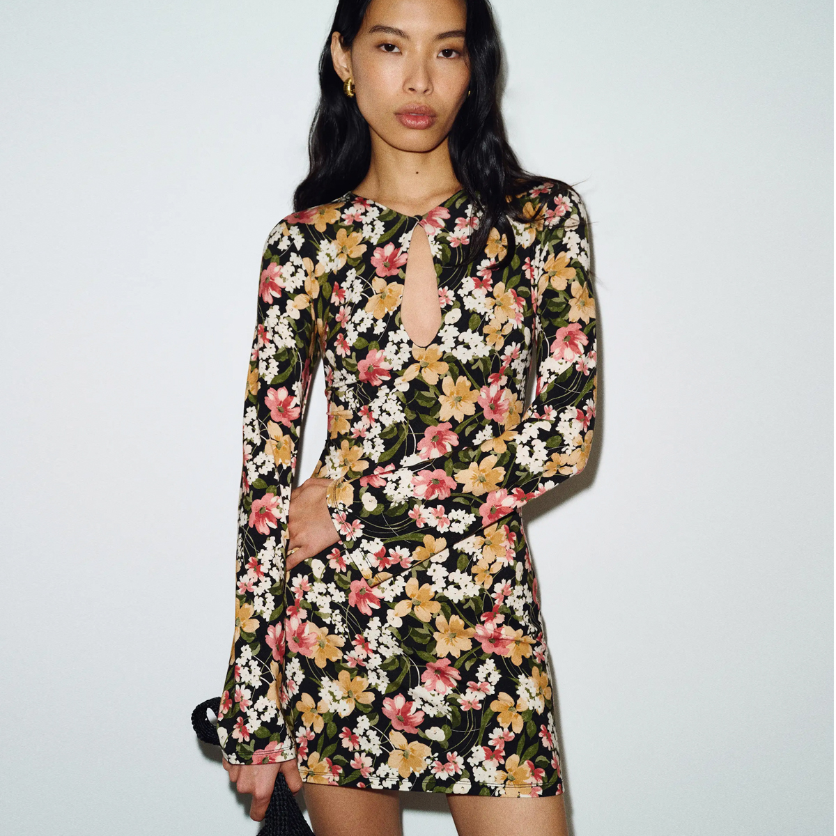 reformation campaign image of a woman wearing a keyhole mini colorful floral dress