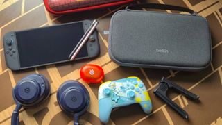 Photo of a spread of Switch 2 accessories and the handheld sitting on a coffee table.