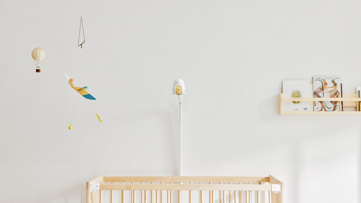 The CuboAi Smart Baby Monitor 3 mounted over a crib in a minimalist nursery