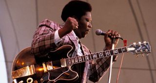 B.B. King pumps his fist as he performs with Lucille in 1979