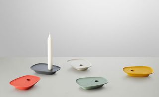 'Float' candle holders, by Muuto. Five candle holders in different colours on a white surface.