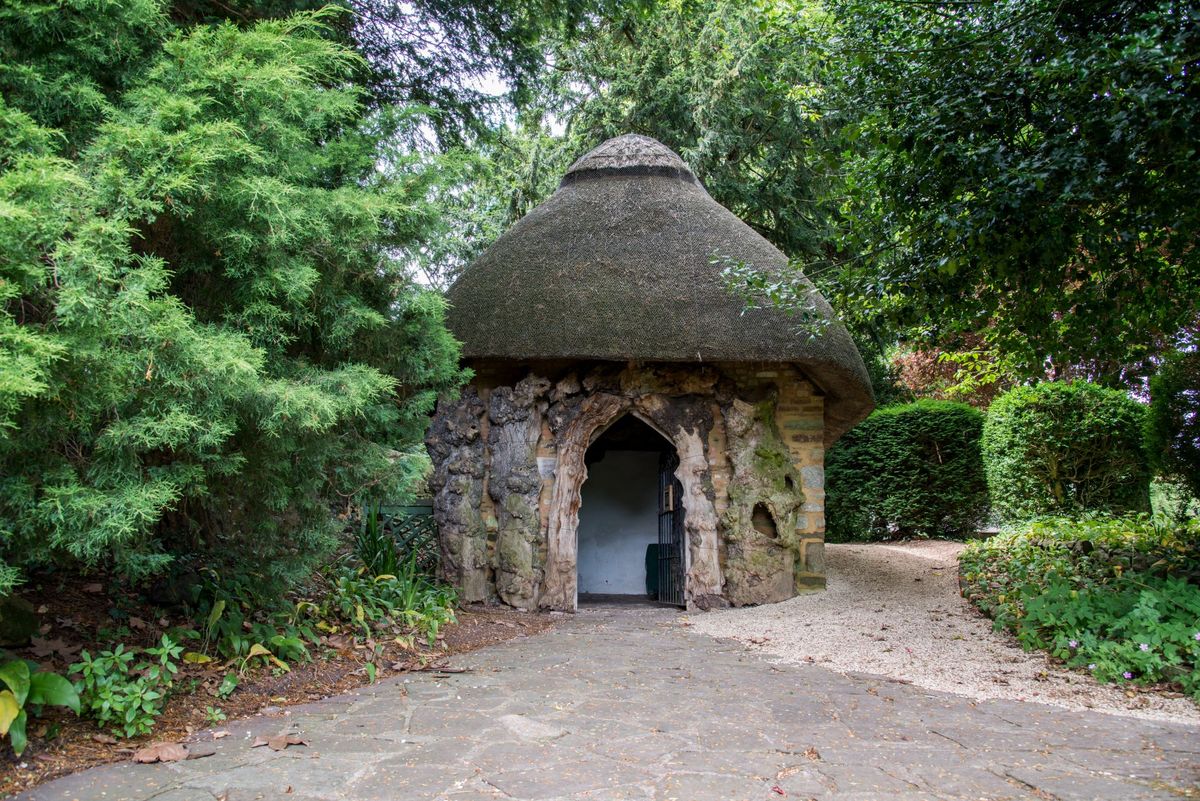A gravelled floor surrounds a straw roofed hut with stone walls for an olden timed garden shed, just another among last year's Shed of the year entries