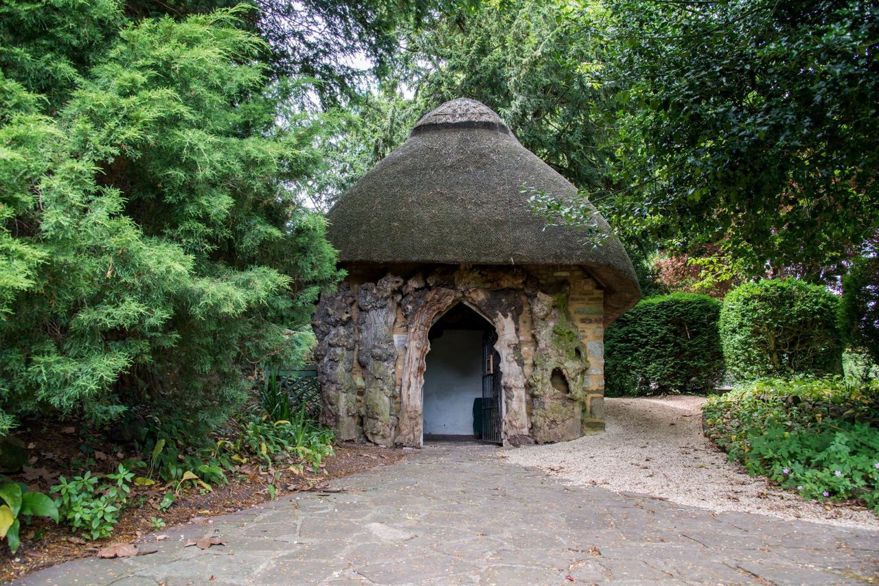 A gravelled floor surrounds a straw roofed hut with stone walls for an olden timed garden shed, just another among last year's Shed of the year entries