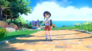 En tränare från Pokemon Scarlet och Violet som står på en kullerstensgata utanför stan