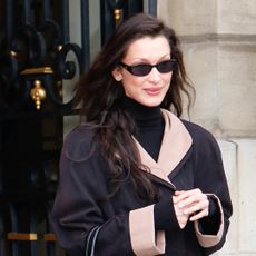 bella hadid leaves her hotel in paris wearing a black colorblock coat with her saint laurent bag and vivaia shoes