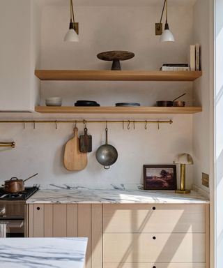 A deVOL kitchen with a brass storage racks and marble counters