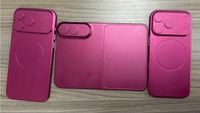 iPhone Fold dummy in magenta with two iPhones nearby.