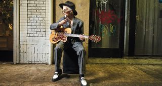 Suited and seated, Carmen Vendenberg plays an ornate vintage Kay singlecut with lipstick single-coils