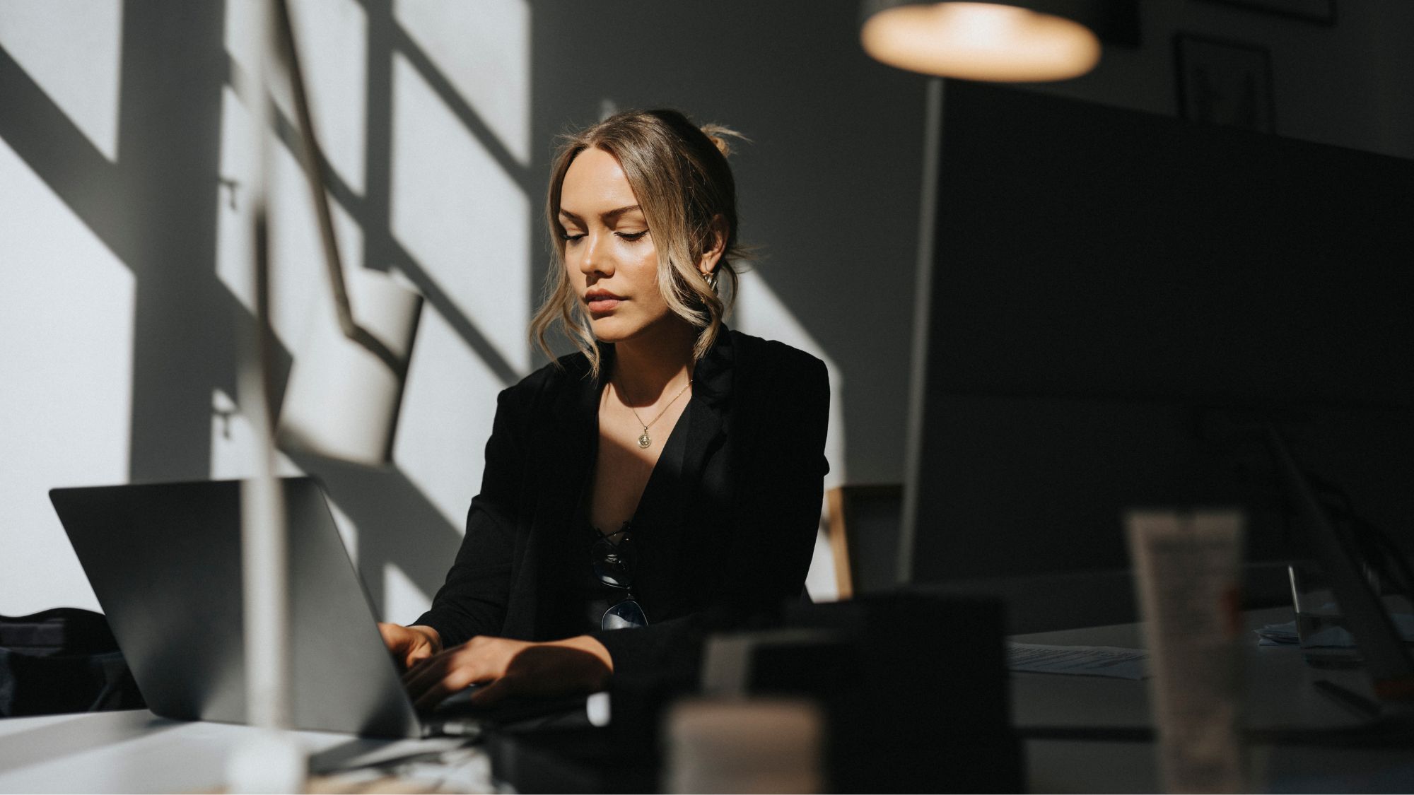 Woman in an office, sat at her desk working