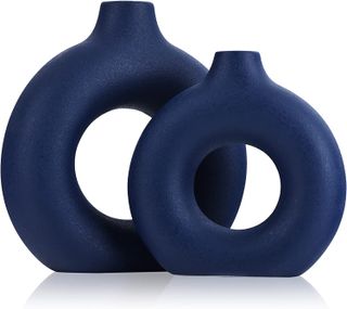 Two blue circular shaped ceramic vases