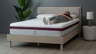 Helix Dusk mattress, with Sleep Editor lying on her back on it