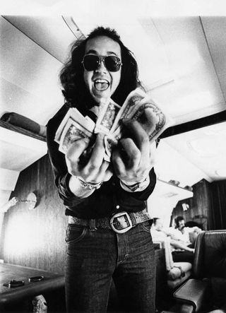 Ian Paice on the Deep Purple jet waving some money