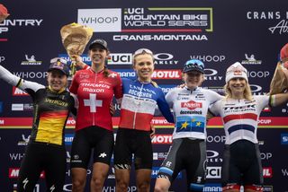 Elite women's podium in Crans Montana for WHOOP UCI MTB World Series XCO race, won by Loana Lecomte