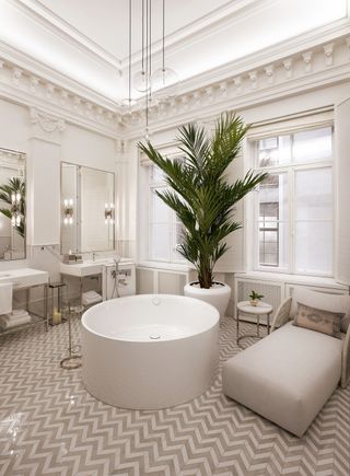 Signature suite bathroom at The Hotel Maria, with round tub and daybed