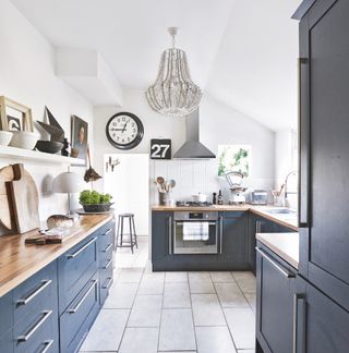 kitchen with grey cabinet and beaded chandelier