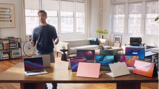 Actor Justin Long in front of Macs and Intel Laptops