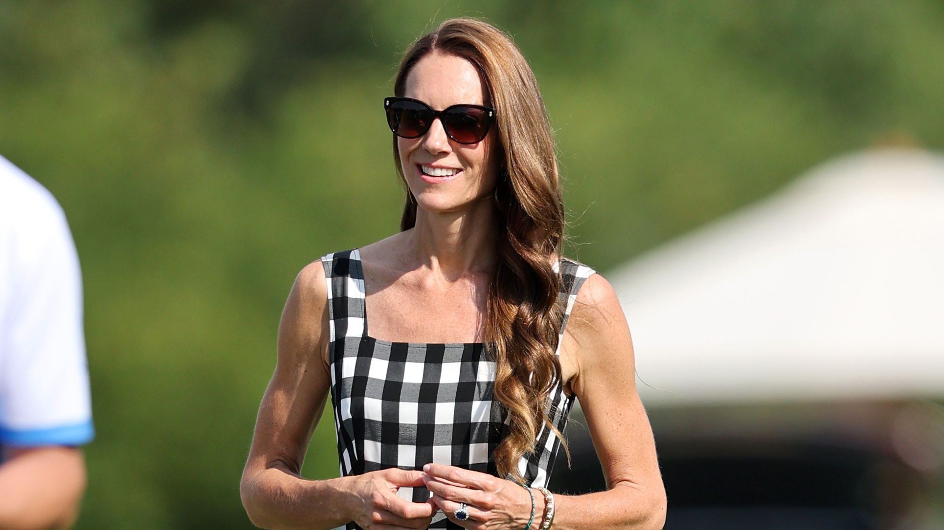 Kate Middleton wearing an A-line black-and-white gingham dress and slingback nude pumps at a charity polo match