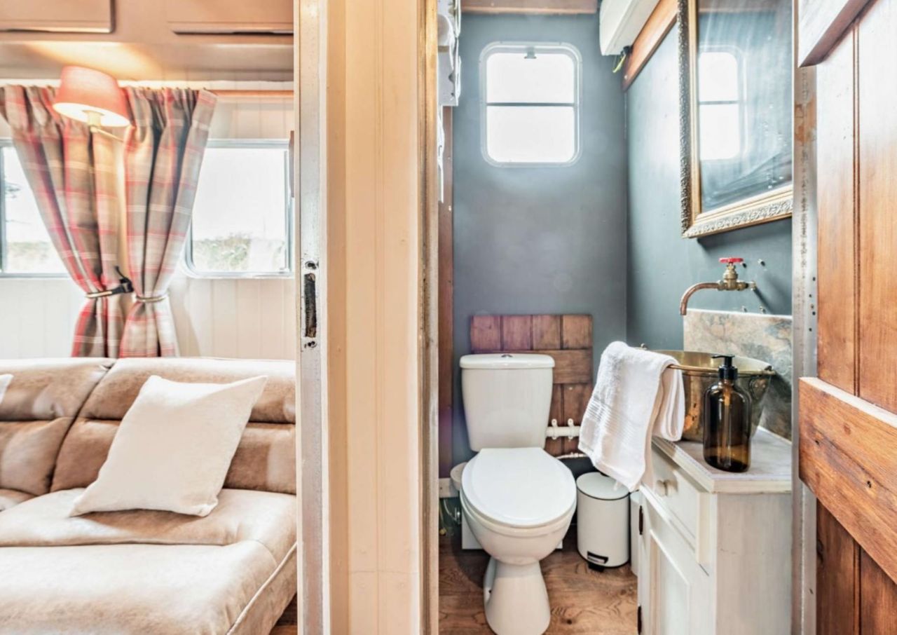 A bathroom with white toilet is connected to the bedroom