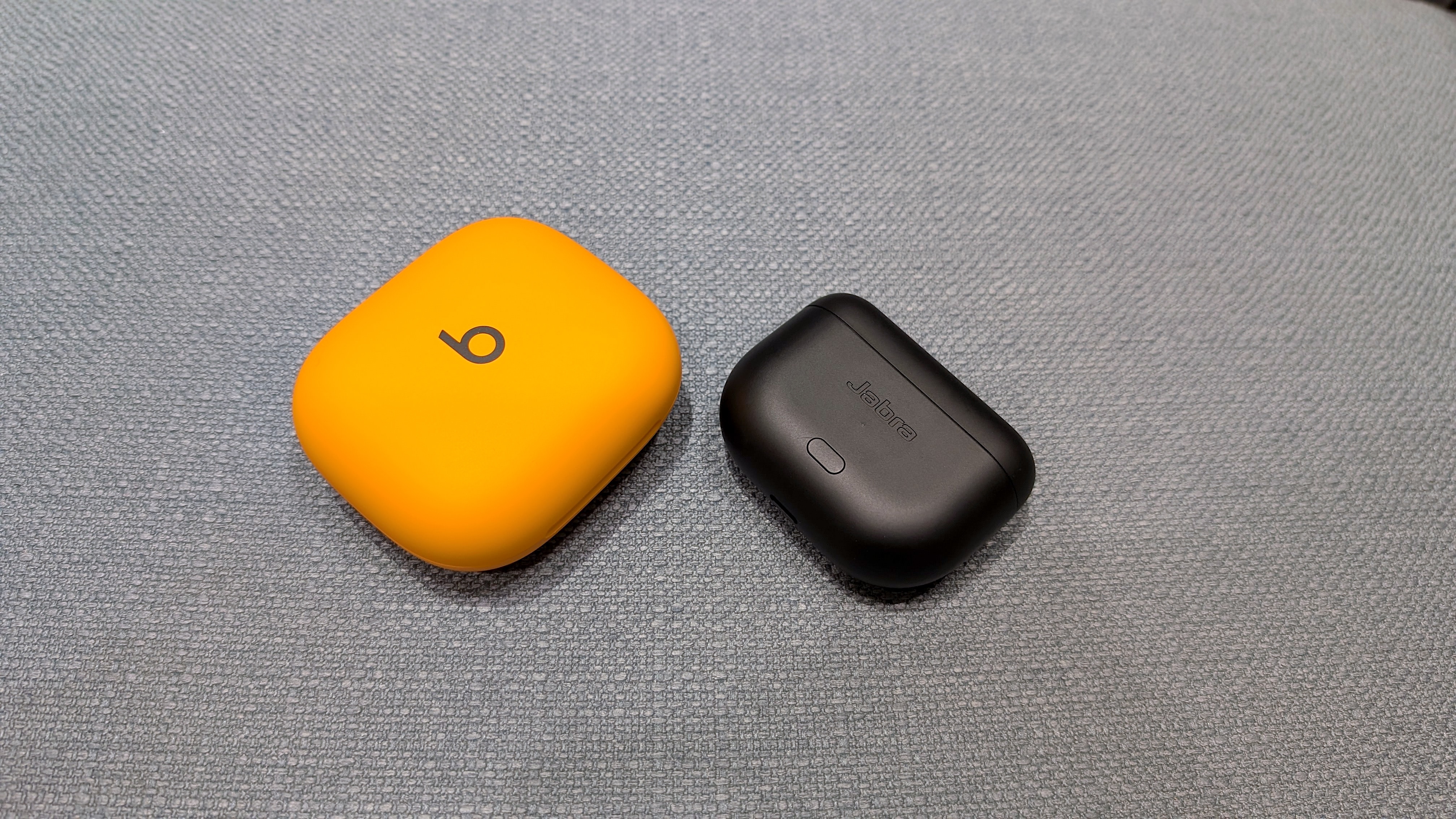 The Beats Powerbeats Pro 2 and Jabra Elite 8 Active Gen 2 charging cases
