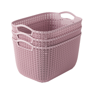 A trio of pastel pink plastic storage baskets with handles