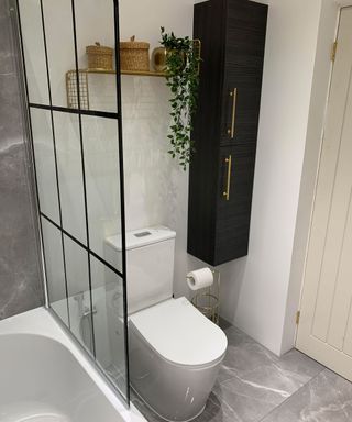 Bathroom with crittal-style shower glass and white tub with toilet