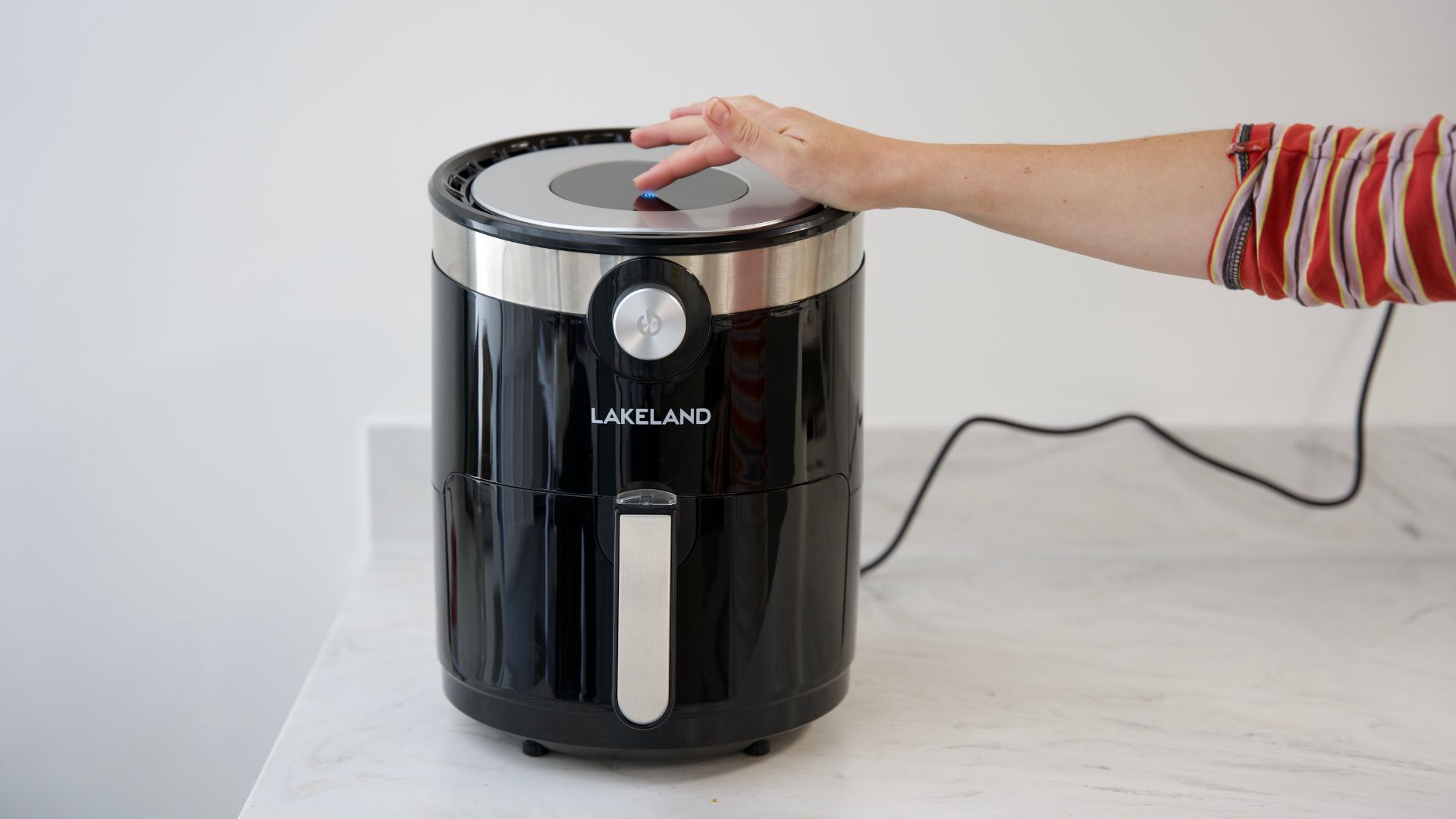 Air fryer being turned on to show the first step of how to use an air fryer