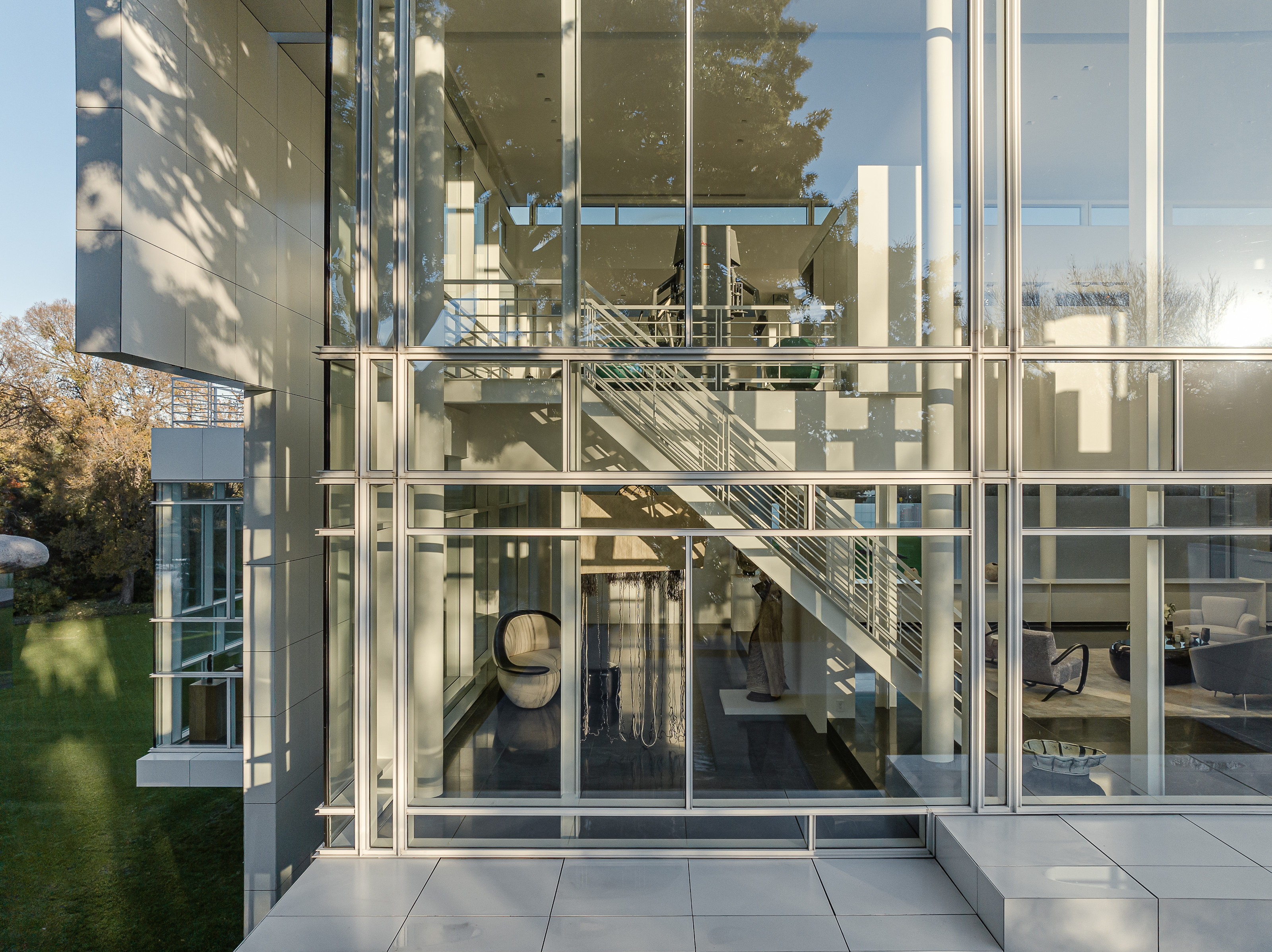 The facade is composed of glass and white metal panels