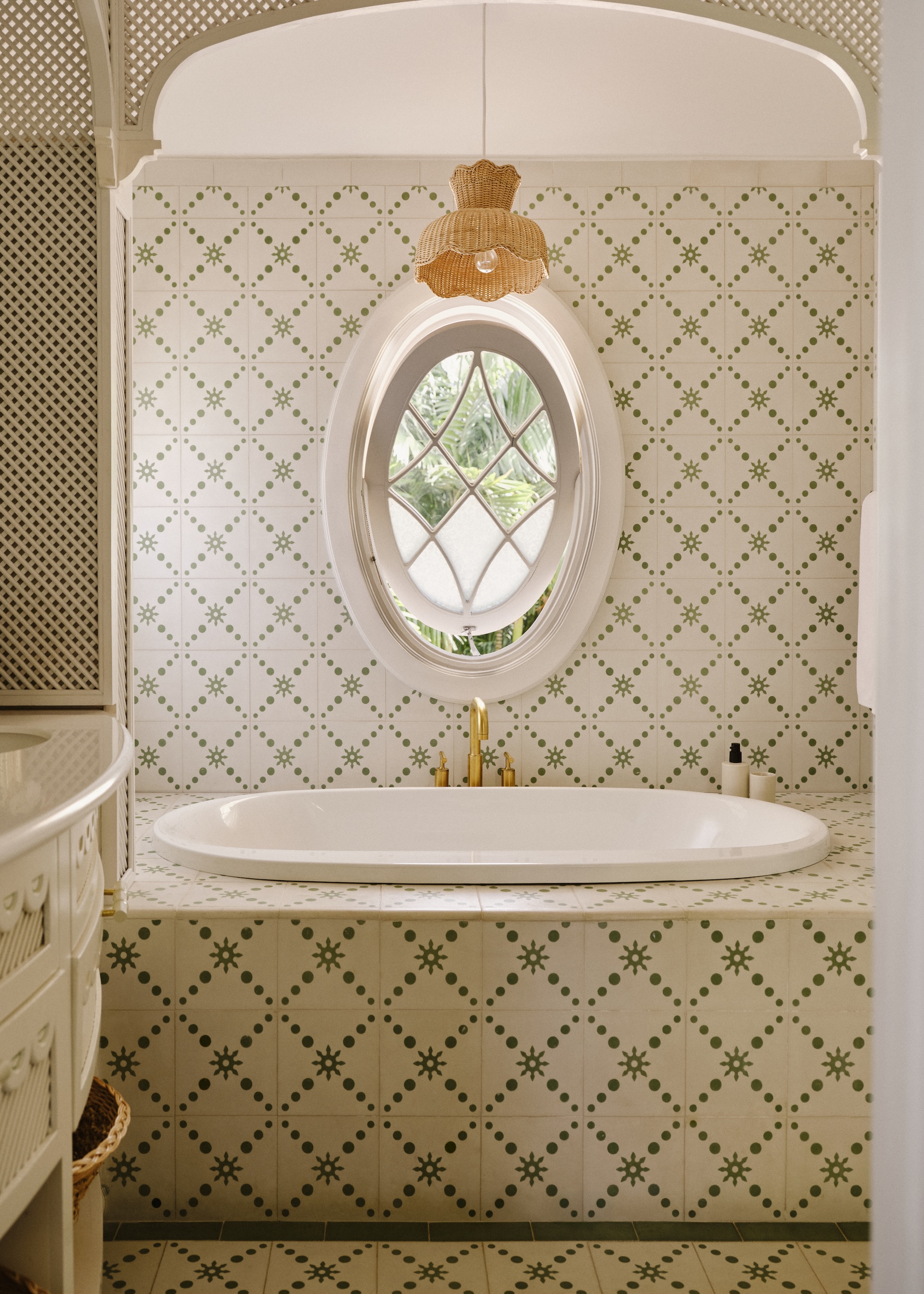 a bathroom with patterned tiles across the wall, bathtub and floor
