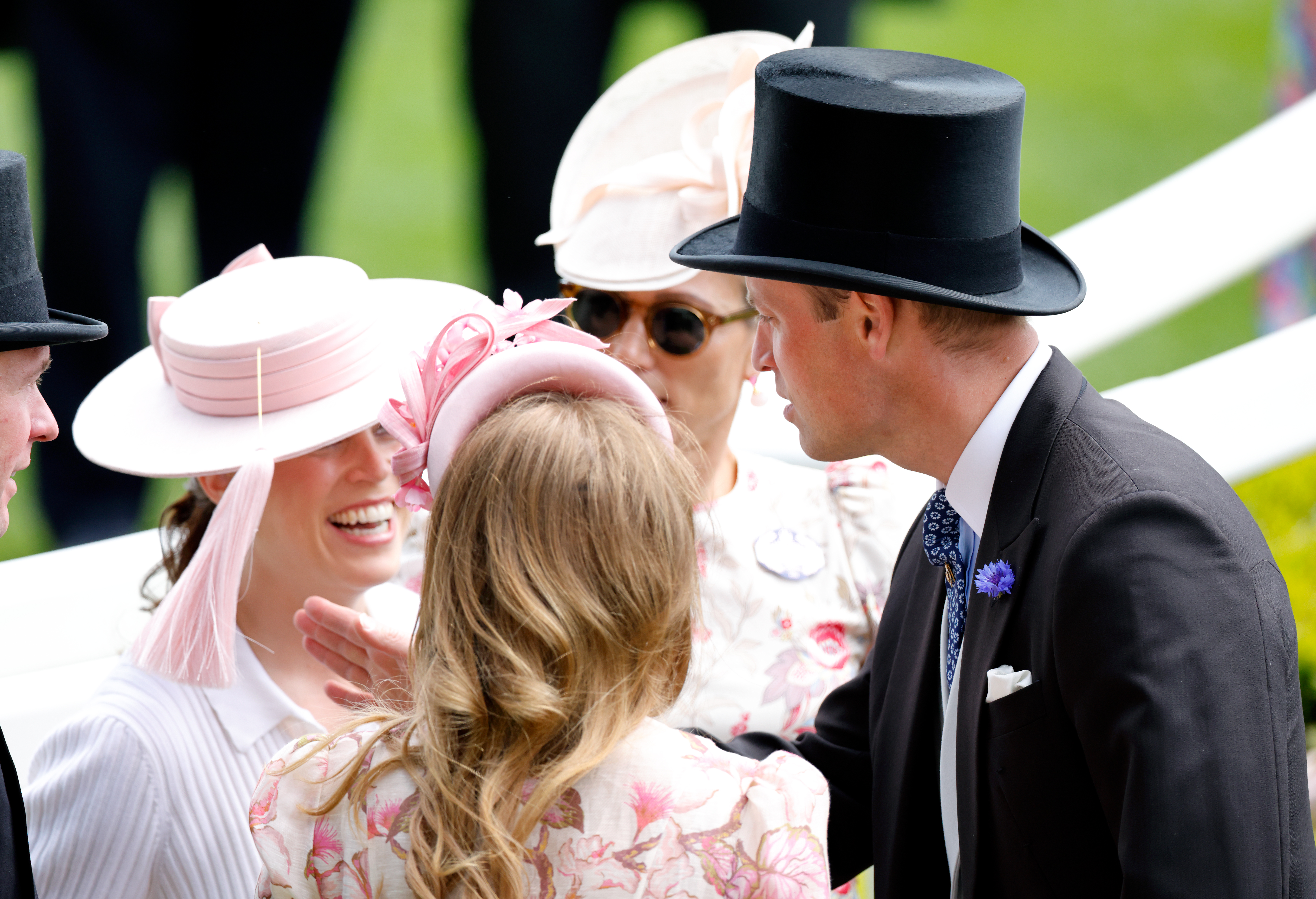 Prince William playing with the tassel on Princess Eugenie's hat