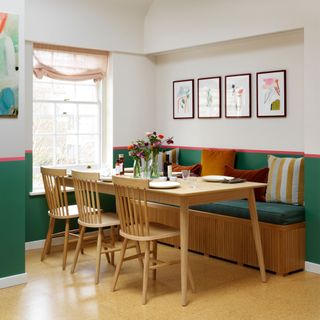 Kitchen with wooden table surrounded by dining chairs and upholstered bench
