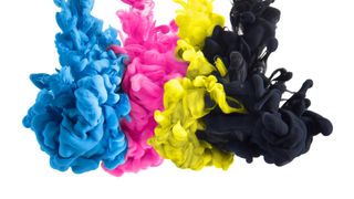 A photograph showing plumes of cyan, magenta, yellow and black printer ink