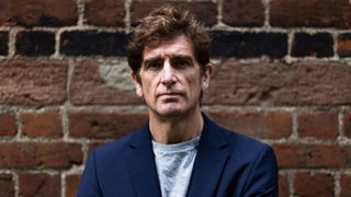 Marcel Theroux photographed in front of a brick wall for The Playboy Bunny Murder